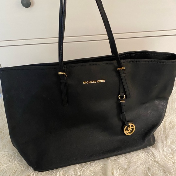 Black leather Michael Kors tote bag with gold-toned accents and flat handles. - Picture 7 of 12